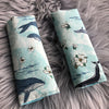 2 padded shoulder strap harness covers for the pram or car seat. Made in a cotton fabric with a light blue whale print fabric - Mini Happy Me